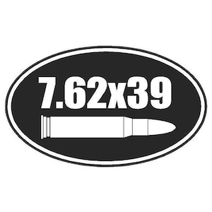 May include: Black and white oval sticker with the text "7.62x39" and a white silhouette of a bullet.