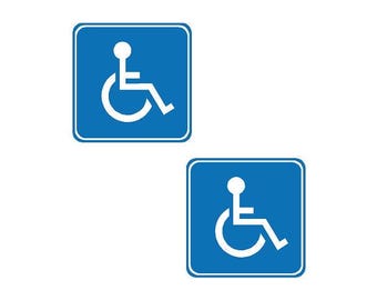 May include: Two blue and white handicap accessible signs. Each sign features a white graphic of a person in a wheelchair inside a blue square with a white border. The signs are identical.
