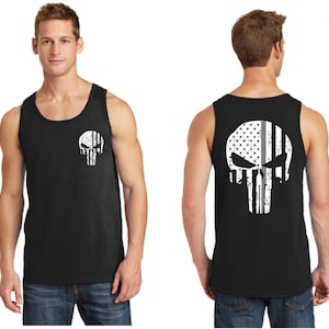 May include: Black sleeveless tank top with a white skull graphic on the front and back. The skull graphic is a stylized American flag with a thin gray line down the middle.