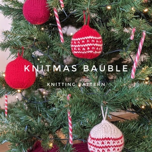 May include: Knit Christmas bauble knitting pattern. A close-up of a Christmas tree decorated with red and white knitted ornaments and candy canes. The ornaments are hanging from the branches of the tree. The text "Knitmas Bauble Knitting Pattern" is displayed on the image.