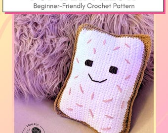 May include: A handmade crochet Pop Tart pillow with a smiling face, pink sprinkles, and a brown border. The pillow is white with a textured surface. The text "POP TART PILLOW" and "Beginner-Friendly Crochet Pattern" are displayed.
