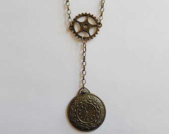 May include: A bronze necklace with a clock face pendant and a gear charm. The clock face has Roman numerals and a delicate design.