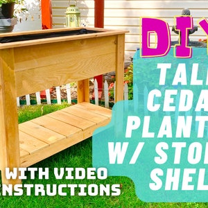 May include: DIY Tall Cedar Planter with Storage Shelf. A wooden planter with a shelf underneath. The planter is made of cedar wood and has a natural finish. The planter is tall and has a rectangular shape. The planter is sitting on a green lawn. The text "DIY Tall Cedar Planter w/ Storage Shelf" is written in pink and yellow letters on a blue background. The text "With Video Instructions" is written in black letters on a red background. A play button is in the bottom left corner.
