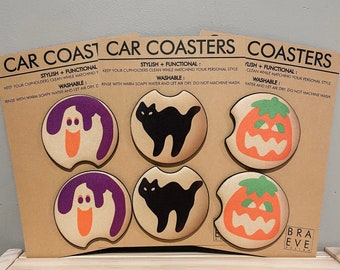 May include: Set of six Halloween-themed car coasters featuring a ghost, a black cat, and a jack-o'-lantern. The coasters are made of a soft, absorbent material and are washable. The text on the coasters reads "Stylish + Functional: Keep your cupholders clean while matching your personal style. Washable: Rinse with warm soapy water and let air dry. Do not machine wash."