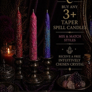 May include: Three textured taper spell candles in red, pink, and purple, each standing in a dark metallic candle holder. Text reads: BUY ANY 3+ TAPER SPELL CANDLES, MIX & MATCH STYLES, RECEIVE A FREE INTUITIVELY CHOSEN CRYSTAL, APPLIES TO ANY TAPER SPELL CANDLES.