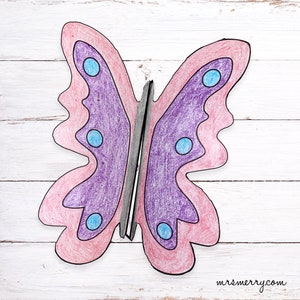 May include: A purple and pink butterfly with blue spots. The butterfly is drawn with colored pencils and has a black outline.