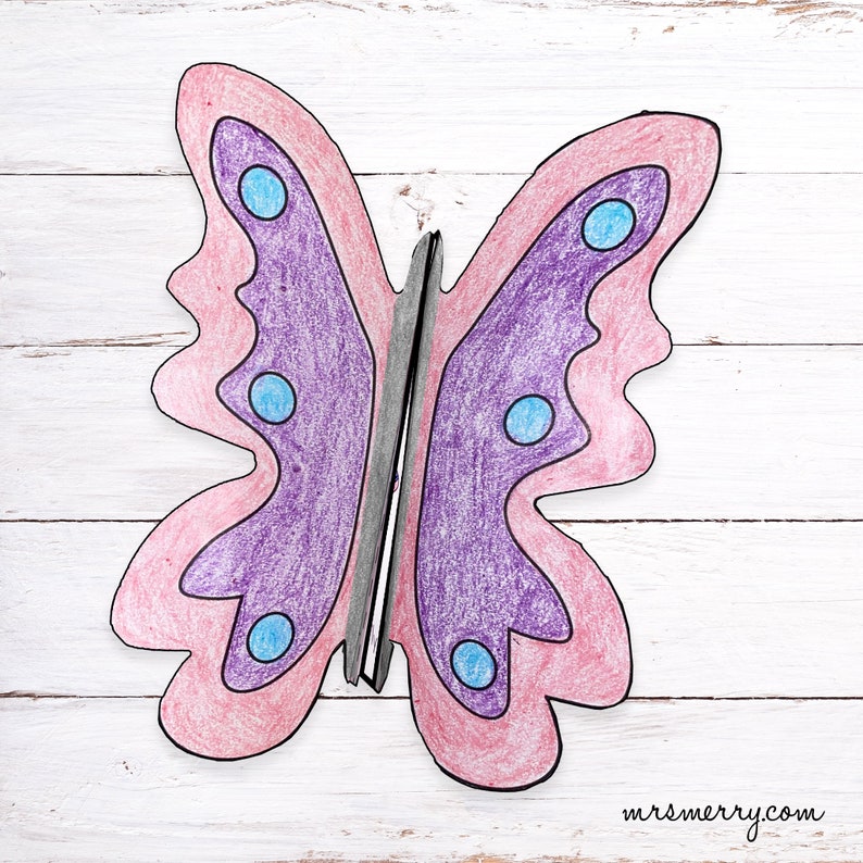 May include: A purple and pink butterfly with blue spots. The butterfly is drawn with colored pencils and has a black outline.