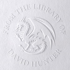 May include: A white embossed circle with the text "From the Library of David Hunter" and a dragon illustration in the center.