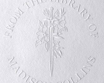 May include: A white embossed circular stamp with the text "From the Library of Madison Collins" and a sword with flowers around it.