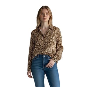 May include: A long-sleeved button-down shirt featuring a brown and black leopard print pattern, paired with blue denim jeans. The shirt has a classic collar and a buttoned front placket, while the jeans are high-waisted with a standard five-pocket design.