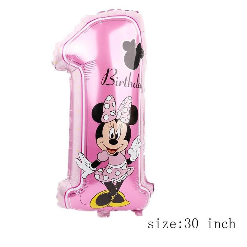 May include: A pink foil balloon shaped like the number one, measuring 30 inches. The balloon features a graphic of a cartoon mouse wearing a polka dot dress and bow, with the word Birthday printed in black script above the character.
