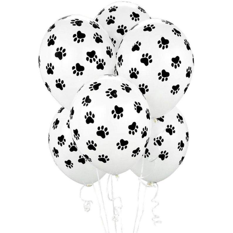 K&ouml;nnte beinhalten: Ein B&uuml;ndel wei&szlig;er Ballons mit schwarzen Pfotenabdr&uuml;cken.
