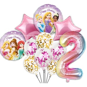 May include: A selection of birthday balloons featuring princess designs. The set includes star-shaped and round foil balloons, confetti-filled balloons, and a number 2 balloon. The colour scheme is pink, purple, and gold.