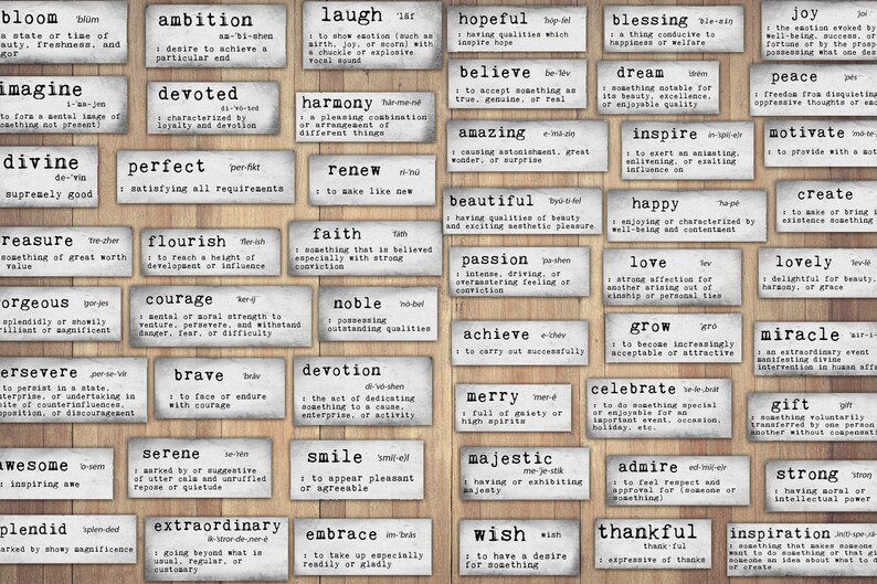 May include: A set of 36 white tiles with black lettering, each tile featuring a positive word and its definition. The tiles are arranged in a grid pattern on a wood background.