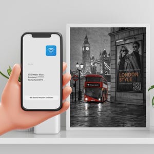 May include: A framed black and white photograph of London with a red double-decker bus, Big Ben, and the Tower Bridge. A smartphone displays a Wi-Fi connection screen. The image also includes a fashion advertisement.