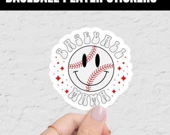 May include: White sticker with a red baseball with a smiley face and the text "Baseball Mama" in a retro font.