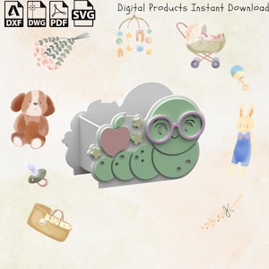 May include: A white wooden pencil holder shaped like a cloud with a green worm with glasses and an apple on top. The worm has a pink nose and purple glasses. The pencil holder is decorated with stars.