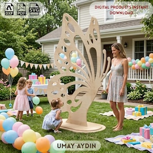 May include: A large, light-coloured wooden butterfly cutout standing on a base in a grassy yard. The butterfly features intricate, open-work wing patterns. Text on the image includes 'DIGITAL PRODUCTS INSTANT DOWNLOAD', 'DXF', 'PDF', 'SVG', and 'UMAY AYDIN'.