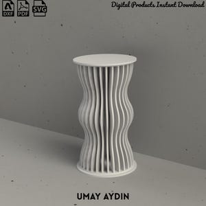 May include: A white cylindrical stand featuring a series of vertical, wavy, slat-like panels arranged around a central core. The design includes icons for DXF, PDF, and SVG file formats, the text Digital Products Instant Download, and UMAY AYDIN.