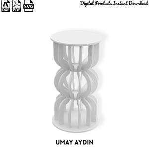 May include: A white cylindrical stand featuring a vertical slatted design with three distinct stacked sections. The structure includes a circular top and base, with curved vertical panels creating an open, airy appearance. Text includes DXF, PDF, SVG, and UMAY AYDIN.
