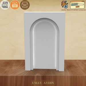 Puede incluir: Una estantería blanca arqueada con un interior empotrado. La estantería es rectangular con una arcada redondeada en el centro. La imagen incluye iconos para los formatos de archivo DXF, PDF y SVG, junto con el texto "DIGITAL PRODUCTS INSTANT DOWNLOAD". El nombre "UMAY AYDIN" está en la parte inferior.