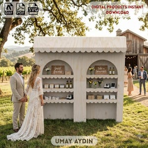May include: A light-colored wooden display stand featuring two arched sections with scalloped shelves. The shelves hold various items, including signs labeled Guest Favors and Take a Souvenir. The structure is designed for outdoor event use.
