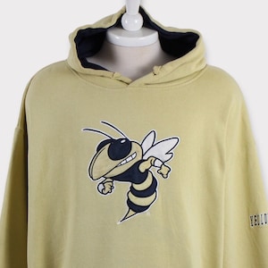 May include: A yellow hoodie with a cartoon bee graphic on the front and the word "YELLOW" on the sleeve.