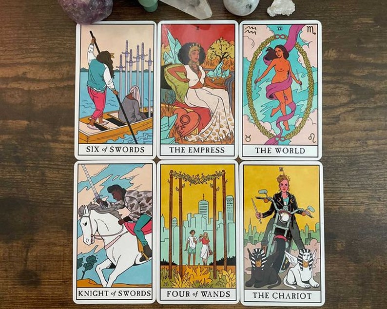 May include: A set of ten tarot cards featuring colorful illustrations of people and symbols. The cards are arranged in two rows of five. The cards include "Six of Swords", "The Empress", "The World", "Knight of Swords", "Four of Wands", and "The Chariot".