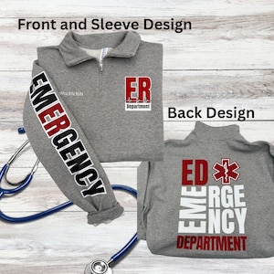 May include: A gray quarter-zip sweatshirt with "ER Department" and "Emergency" printed on the front and sleeve. The back design features "ED Emergency Department" in red and white. A stethoscope is draped across the sweatshirt.