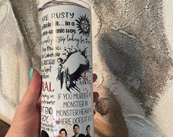 May include: White tumbler with a black and white graphic of characters from the TV show Supernatural. The graphic includes the characters Dean Winchester, Sam Winchester, and Castiel. The text on the tumbler reads "ARE RUSTY a little bit... in a non-sa anic way. The Music: Cakeh ole ALGREAT AGAIN light tion RAL CASTIEL Trophy in IF YOU MURDER. rome MONSTER IN NTEND MONSTER HEAVEN BOYWHERE DOES IT GOP NEEDLESSLY NS TEND TO DO OJITS"