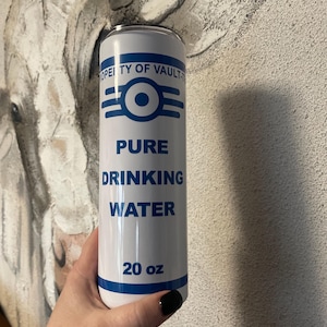 May include: A white stainless steel tumbler with a blue and white Vault-Tec logo and the text "Pure Drinking Water" and "20 oz".