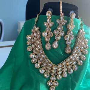 Gold Kundan neck set with earrings and tikka