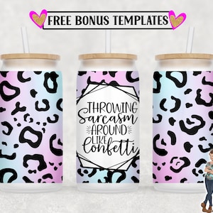 May include: Three white can coolers with a wood-like lid and a straw. The center cooler has a black and white graphic with the text "Throwing Sarcasm Around Like Confetti". The left and right coolers have a pink and blue leopard print.