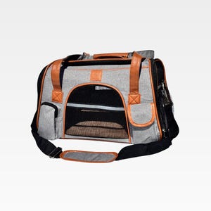 May include: Gray pet carrier with brown leather accents. Features a black mesh window for ventilation and a top handle. Includes a black shoulder strap for easy carrying. The carrier has a small pocket on the side.