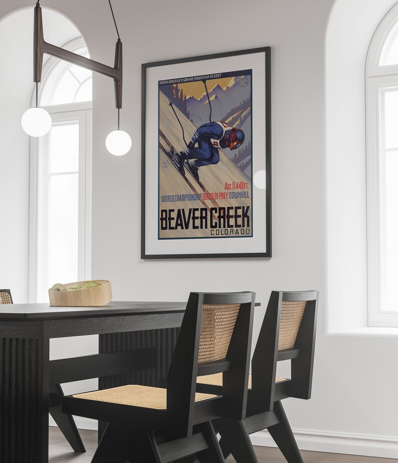 May include: A vintage poster advertising Beaver Creek, Colorado, a North American Grand Mountain Resort. The poster features a skier in a blue and red suit racing down a snowy mountain slope. The text on the poster reads "Alt. 11440ft. World Championship Skiing - Kings of Frey Downhill. Beaver Creek, Colorado."