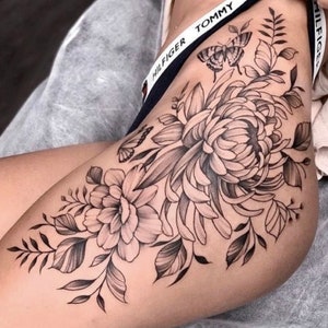 Get now this beautiful and sensual flower, peony and chrysanthemum and butterfly tattoo design.