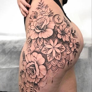 Get this beautiful and sensual tattoo design of flowers, mandalas and moon with stars for the thigh