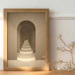May include: A framed print of a hallway with a series of arches leading to a light at the end. The arches are beige and the walls are a light brown. The print is in a wooden frame.