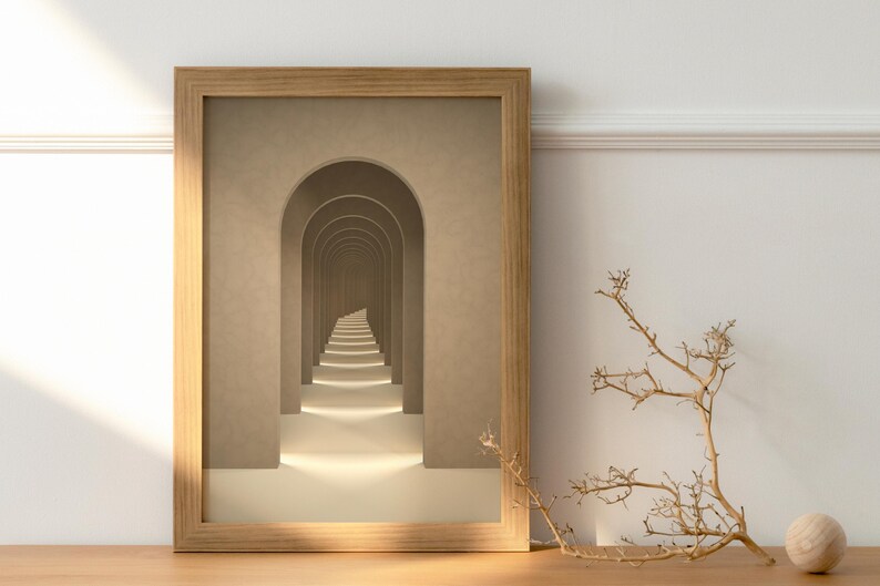 May include: A framed print of a hallway with a series of arches leading to a light at the end. The arches are beige and the walls are a light brown. The print is in a wooden frame.
