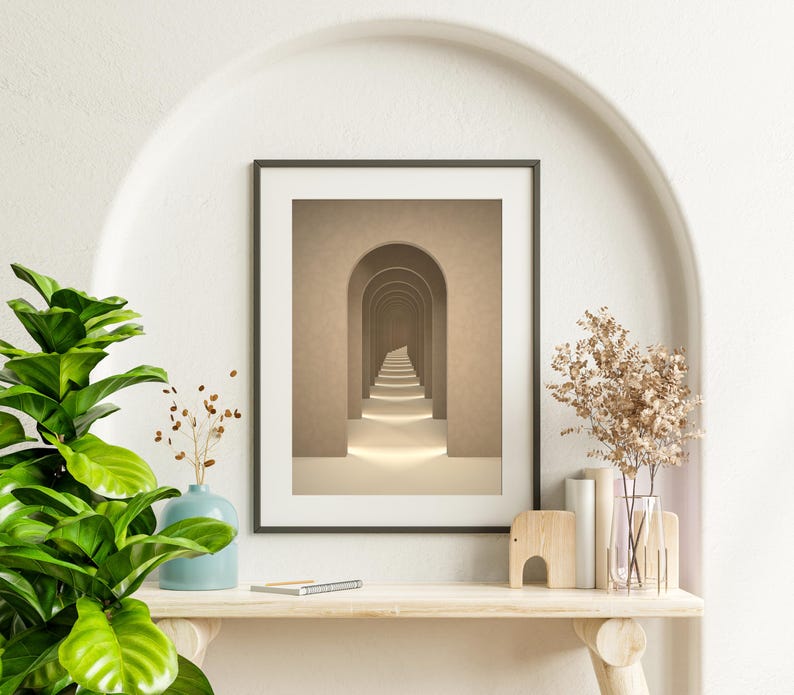 May include: A framed print of a hallway with a series of arches leading to a light at the end. The arches are a light brown color and the walls are a slightly darker brown. The floor is a light beige color.