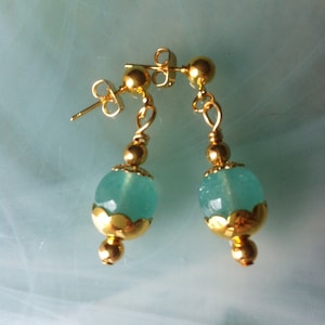 Minimalist earrings made up of two Aqua colored Quartz pearls surrounded by lace cups and gold plated pearls