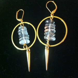 Earrings with a stack of free-form discs of Rutilated Quartz in a gold-plated hoop and spike charm