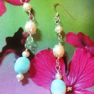 Earrings with freshwater pearls surrounded by silver cups and two blue opal pearls from Peru and 925 Sterling silver hooks