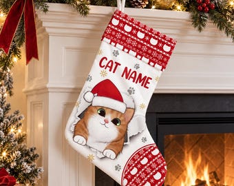 May include: A white Christmas stocking featuring a red and white knit-style pattern at the top and bottom. The center displays a cartoon orange tabby cat wearing a Santa hat, surrounded by gray paw prints and gold snowflakes, with the text CAT NAME.