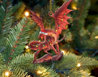 May include: Red dragon Christmas ornament with a Santa hat that says "DAVID" on it. The dragon is wrapped in red and green Christmas lights.