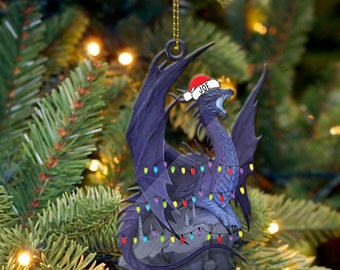 May include: A purple dragon wearing a red Santa hat with the name "JOE" on it. The dragon is surrounded by colorful Christmas lights and is sitting on a rock.