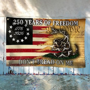 May include: A flag with a distressed American flag design, featuring the text "250 YEARS OF FREEDOM" and "DON'T TREAD ON ME." The flag includes a coiled rattlesnake and the years 1776 and 2026.