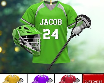 May include: Green lacrosse jersey with white trim and the name "JACOB" and number "24" on the front. A green lacrosse helmet and a black lacrosse stick are included in the image.