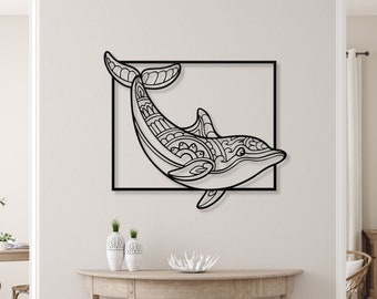 May include: Black metal dolphin wall art with intricate patterns within the dolphin's body, set within a black rectangular frame. The artwork is displayed on a neutral-colored wall, adding a touch of coastal decor.