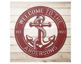 May include: Red metal sign with a white anchor and rope design. The sign reads "Welcome to the Andersons Est. 2022".